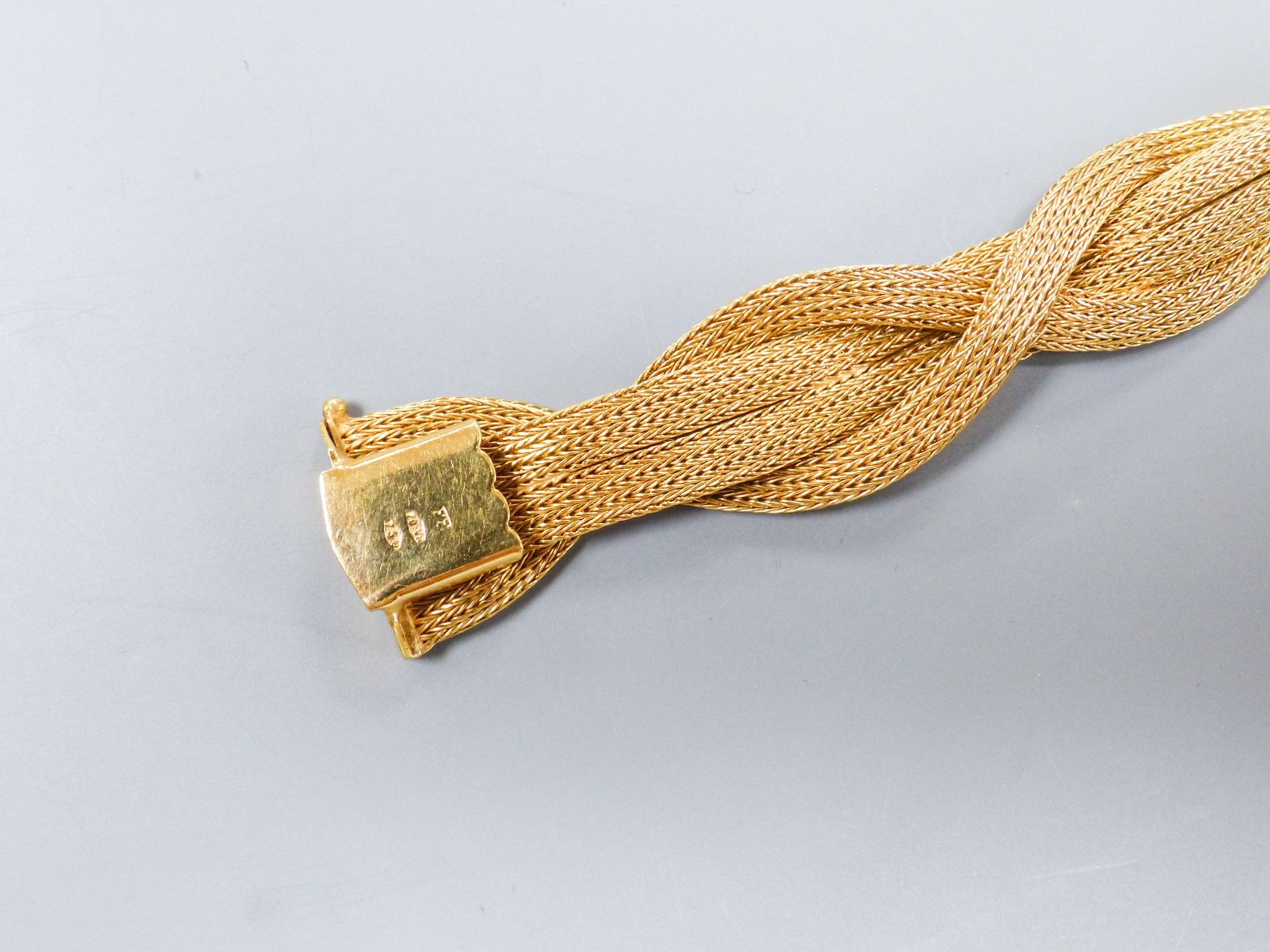 An 18ct gold plaited mesh bracelet, 19cm, 31 grams (repair).